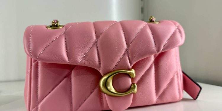 Coach’s timeless shoulder bag is now available in a trendy spring color — Flower Pink