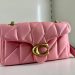 Coach’s timeless shoulder bag is now available in a trendy spring color — Flower Pink